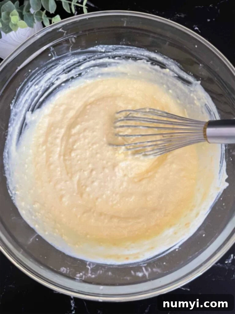 Lush Coconut Cream 8 Coconut cream pudding mixed with the half and half in a glass mixing bowl.