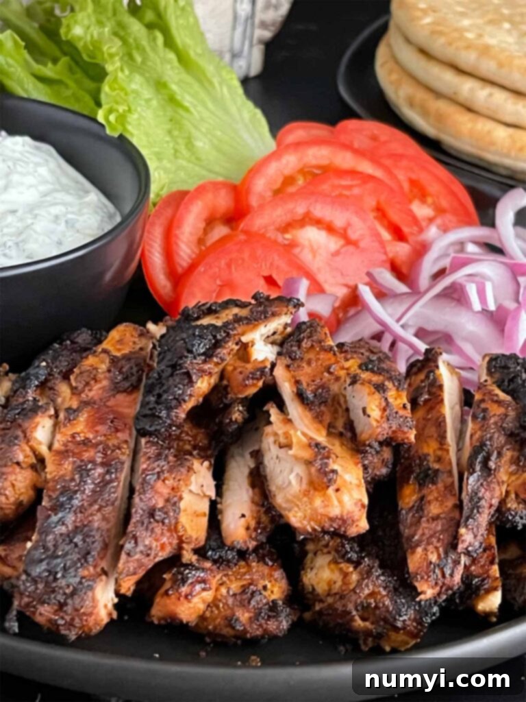 Platter of freshly grilled and sliced chicken shawarma, ready to be served.