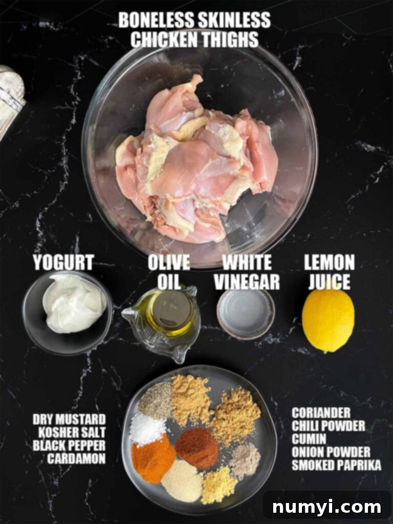 A vibrant selection of spices and marinade ingredients laid out on a dark surface, ready for grilled chicken shawarma preparation.