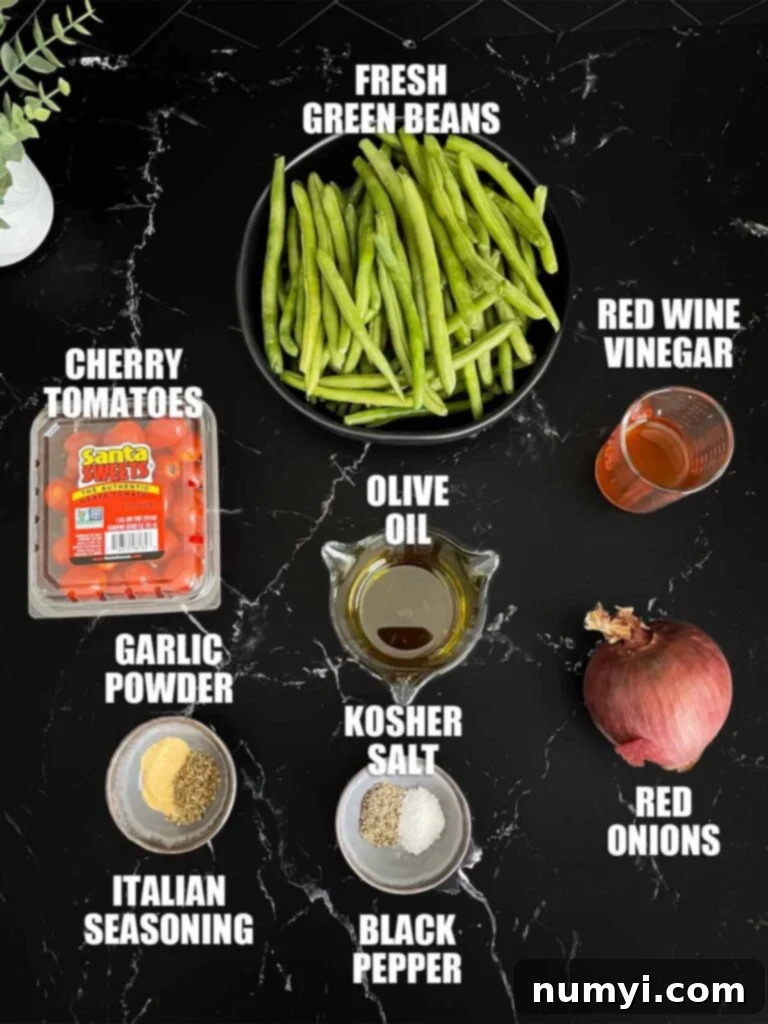 Italian green bean salad recipe ingredients on a dark surface.
