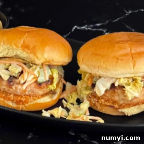 Zesty Carolina Grilled Chicken Burgers 21 Grilled Carolina chicken burgers on a black plate.