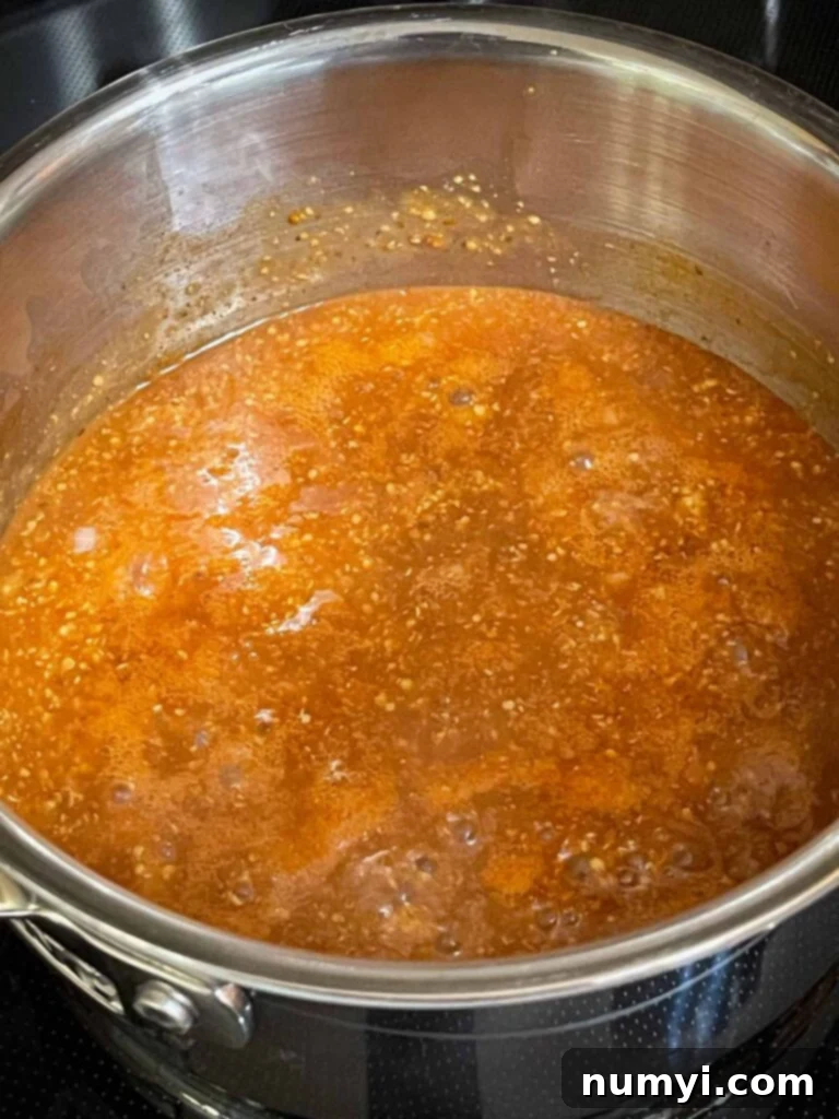 Zesty Carolina Grilled Chicken Burgers 7 Carolina barbecue sauce simmering in a saucepan.