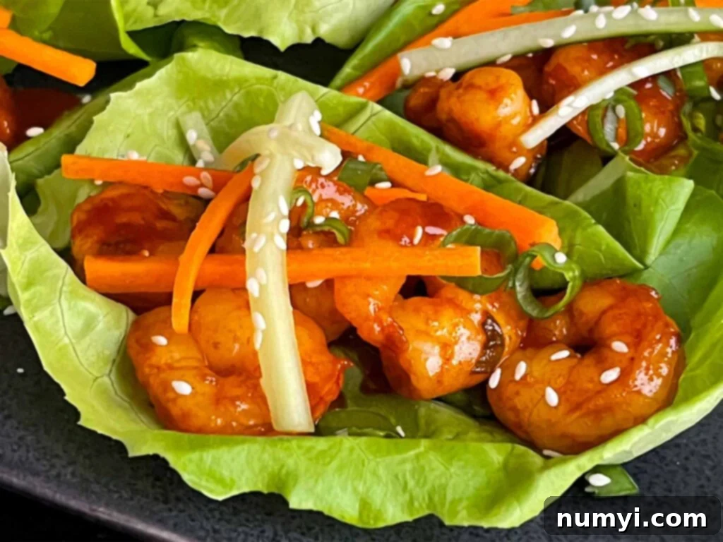 Gochujang shrimp lettuce wraps, perfectly assembled and ready to eat, showcasing vibrant colors and fresh ingredients.