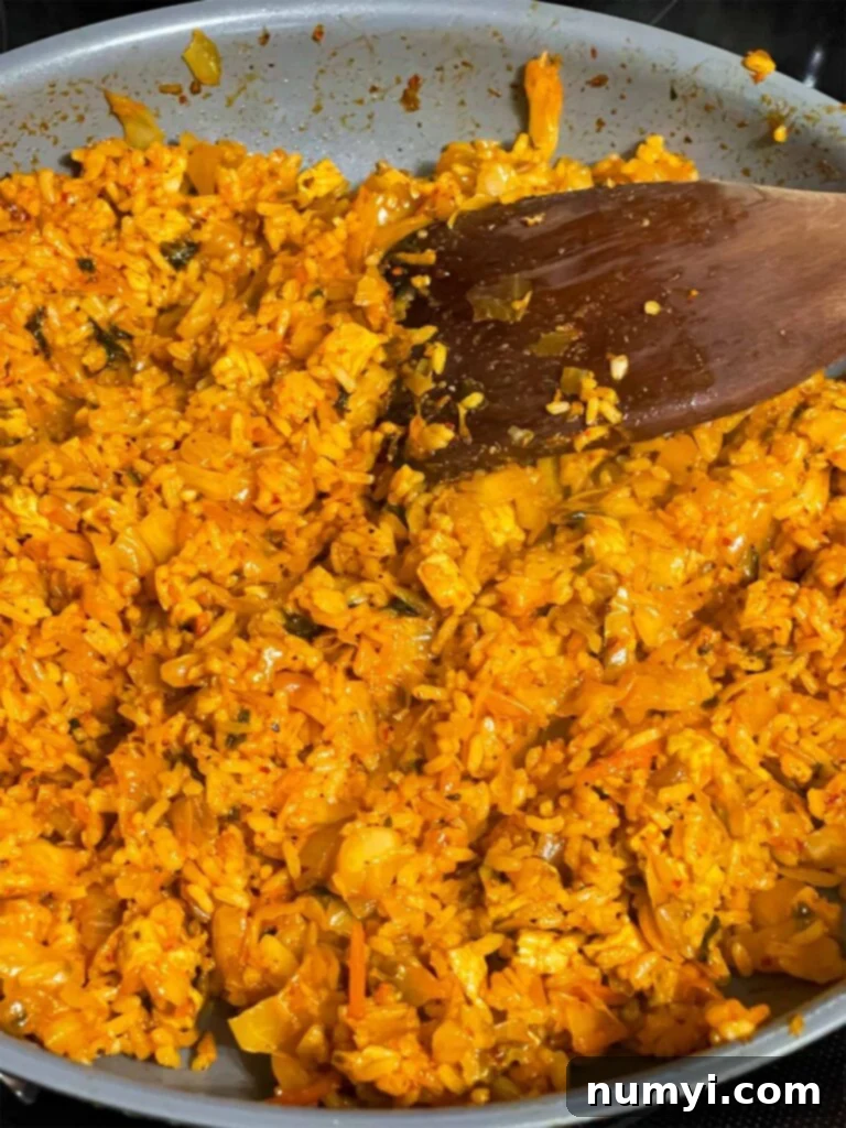 Crispy kimchi fried rice with perfectly toasted grains in a wide skillet, ready for plating.