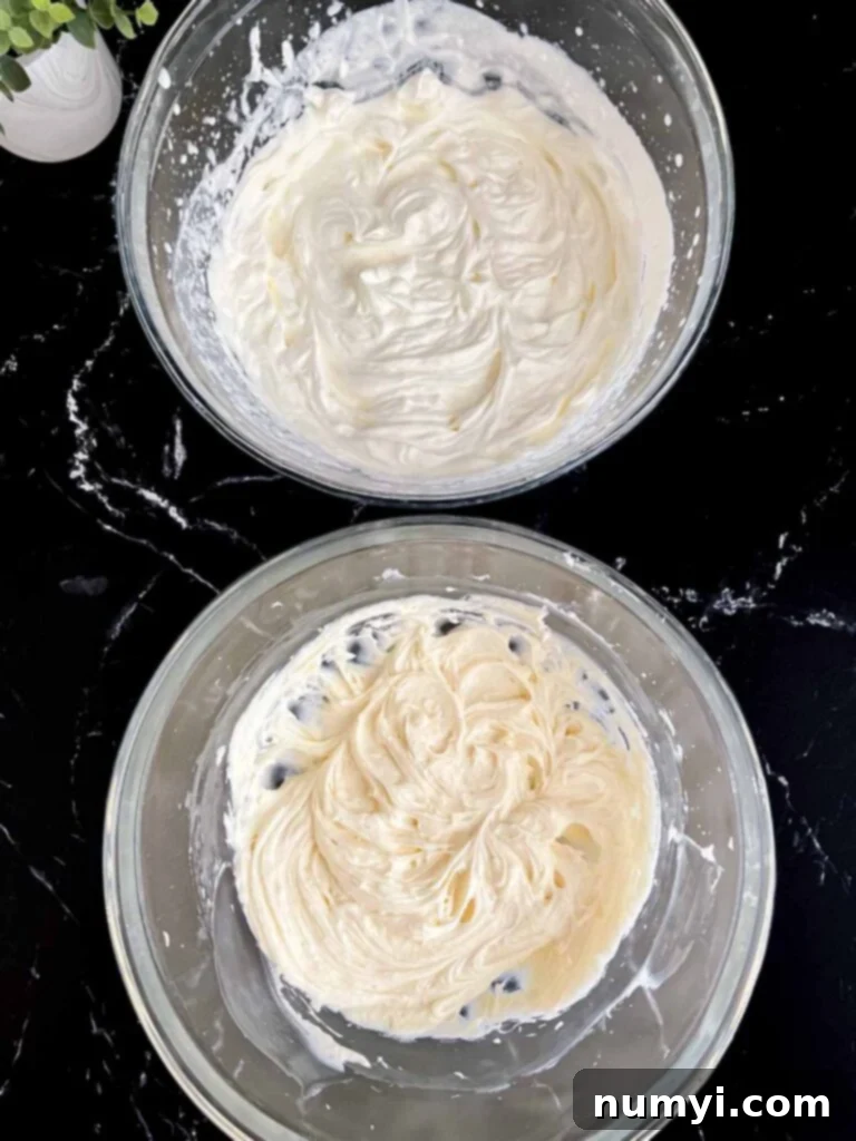 Luscious Berry Poke Cake 12 Two separate glass bowls: one holding perfectly whipped heavy cream, the other containing smooth cream cheese mixture, ready to be combined for the frosting.