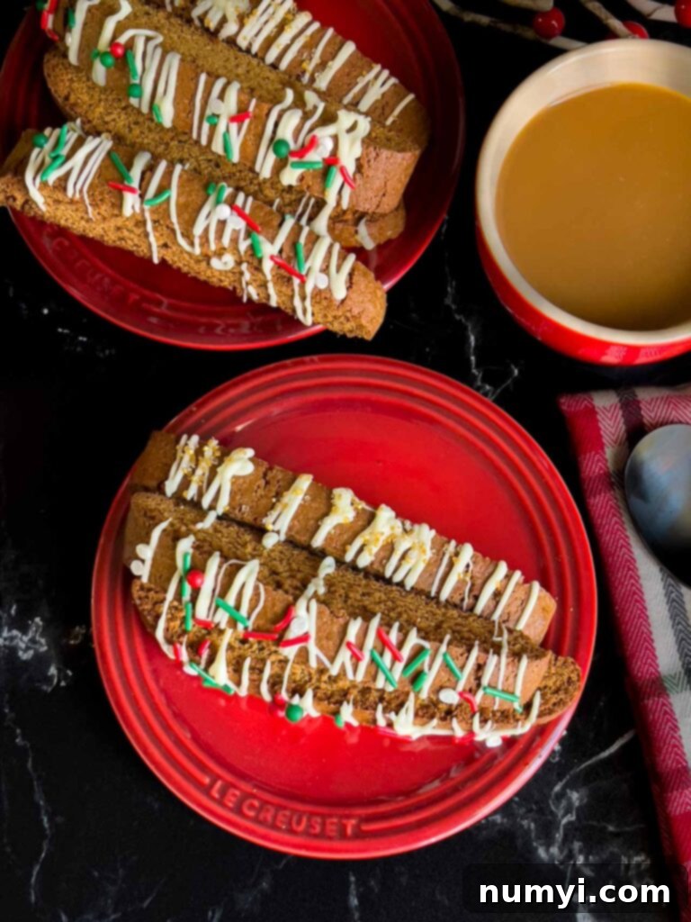 Gingerbread biscotti on a red plate with a cup of coffee.