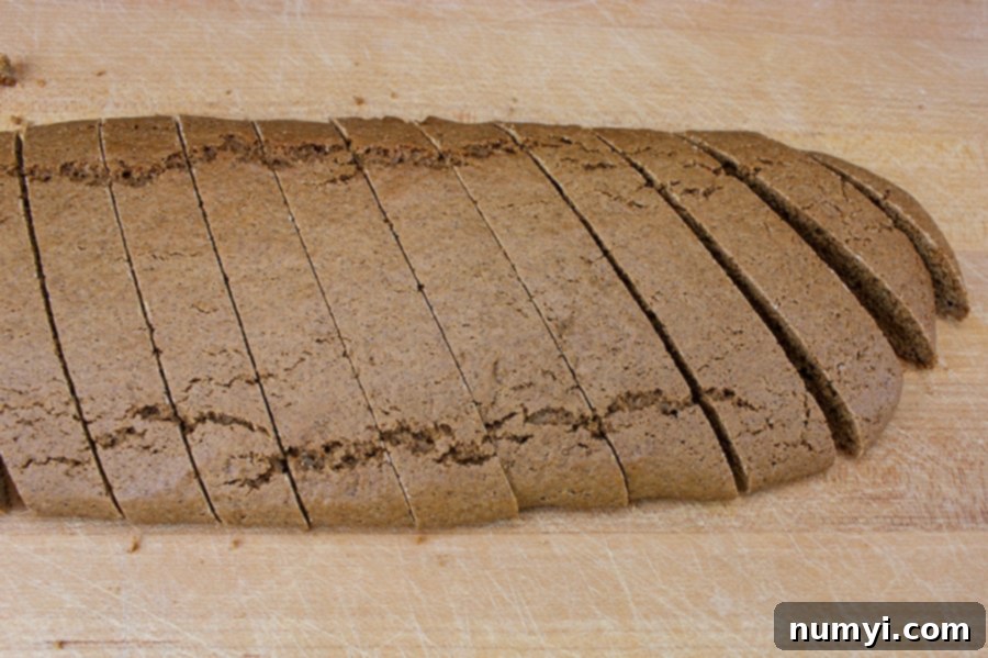Gingerbread Biscotti sliced on a wooden cutting board.
