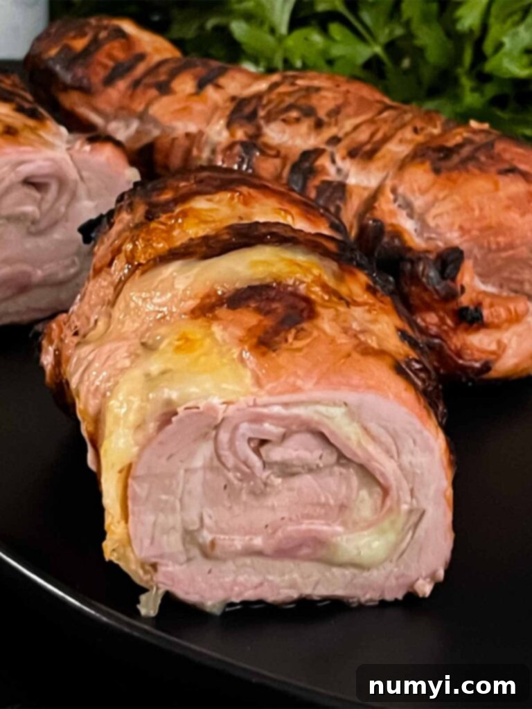 Grilled Cuban Pork Tenderloin sliced into medallions, showing the stuffed interior.