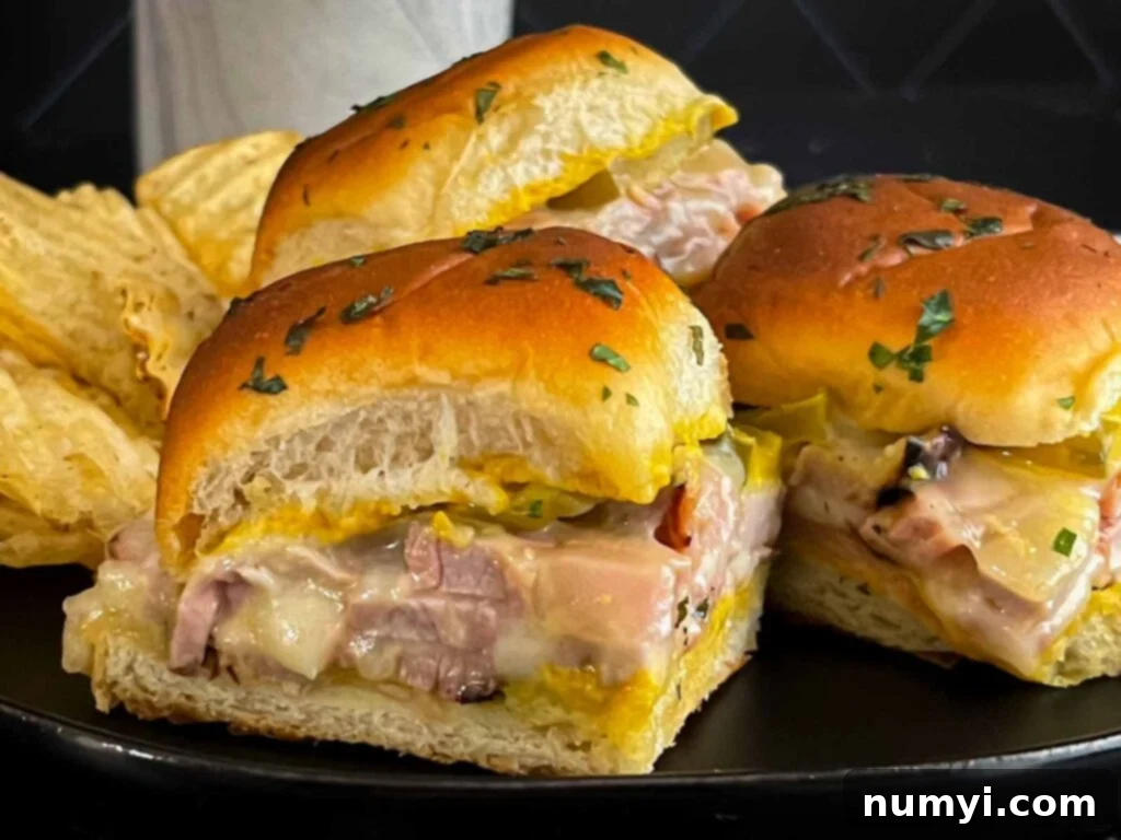A platter of mini Cuban sliders made with roll-cut pork tenderloin.