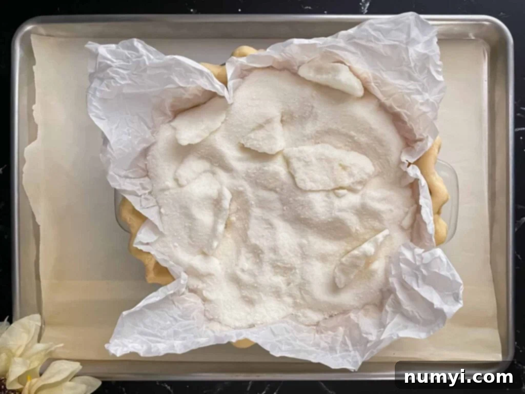 Homemade Apple Butter Pie 4 Homemade pie shell with a sugar weight in it for baking.