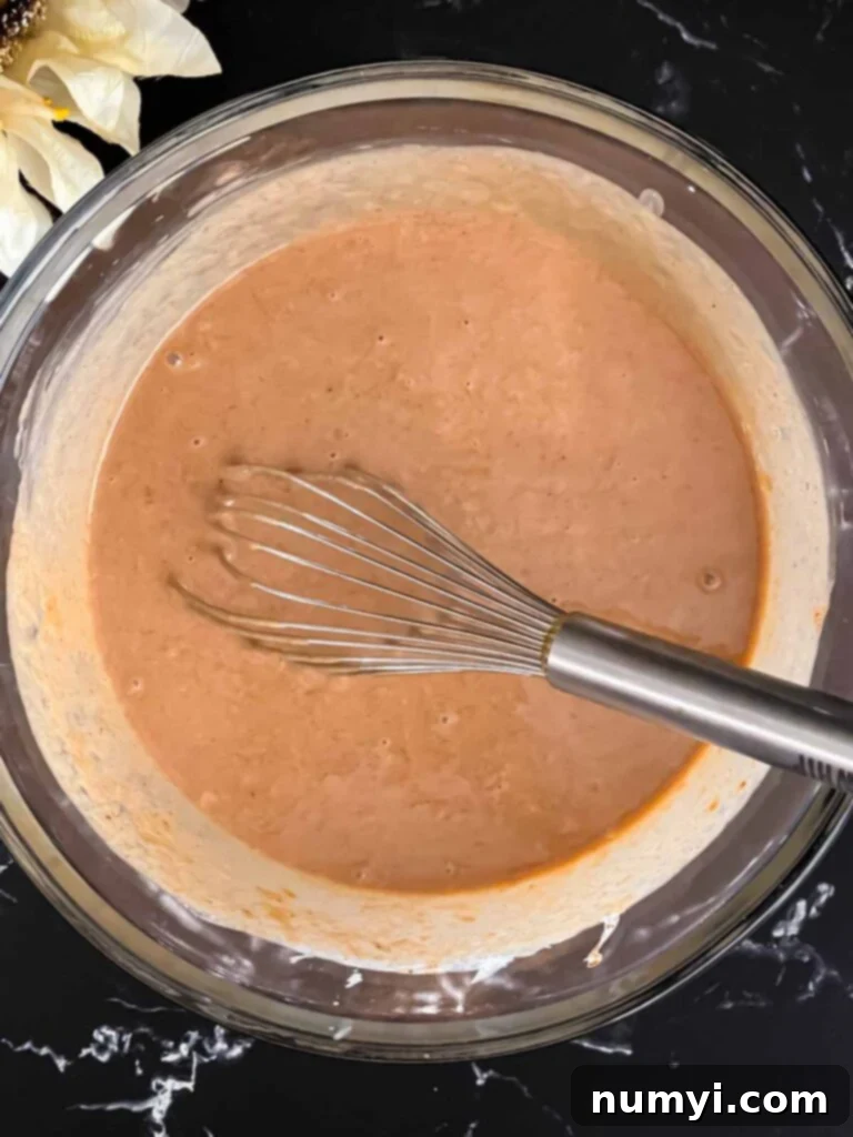 Homemade Apple Butter Pie 6 Apple butter pie mixture whisked together in a glass bowl.