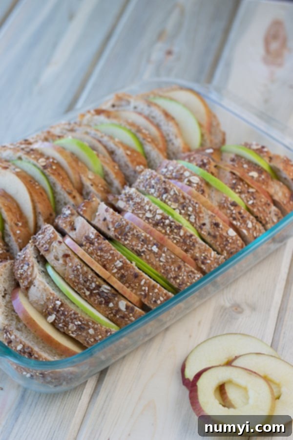 Overnight Apple Cinnamon French Toast Bake 3 layers of apple and toast arranged in a baking dish