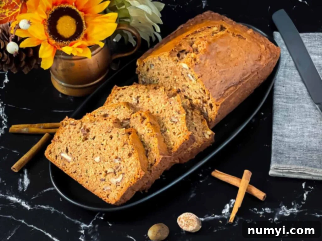 Moist Zucchini Bread 2 Sliced zucchini bread loaf on a dark oval platter on a dark surface.