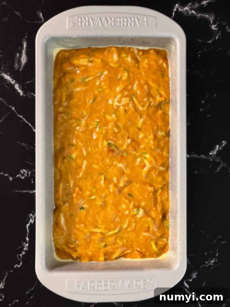 Moist Zucchini Bread 8 Zucchini bread batter in a greased loaf pan.