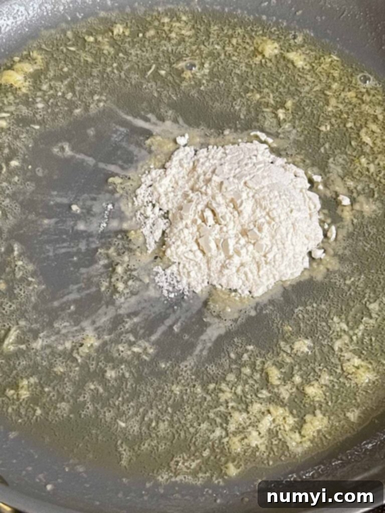 Butter, garlic, and flour cooking in a skillet.