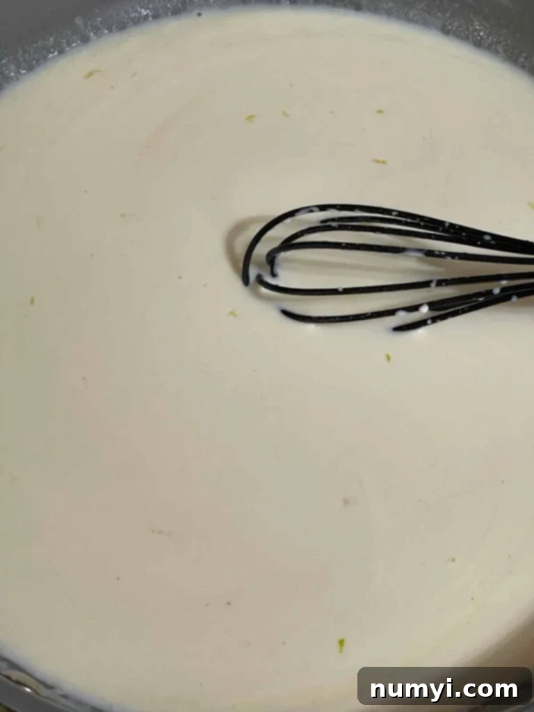 A creamy Alfredo sauce in a skillet.