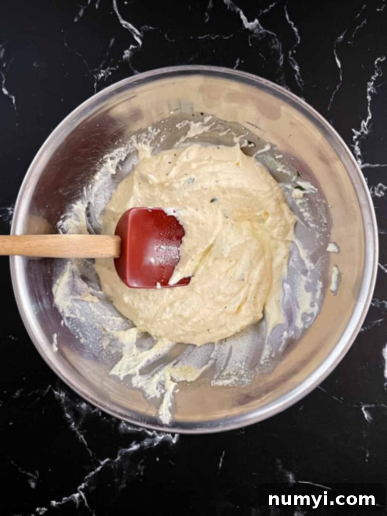 Creamy Baked Ricotta 7 The ricotta dip mixture, perfectly blended and ready for the next step, showcasing its smooth and creamy texture.