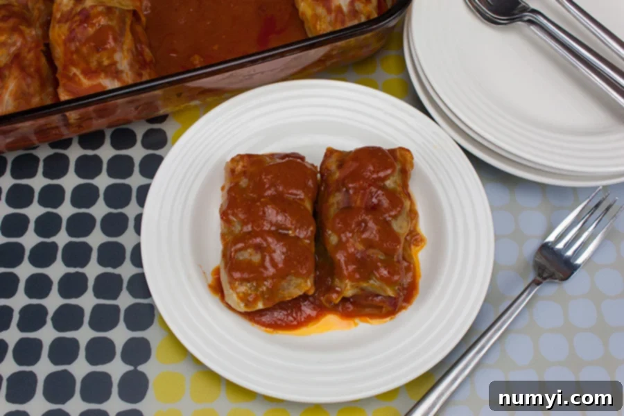 Close-up of easy stuffed cabbage rolls on a white plate, highlighting the delicious filling and sauce.