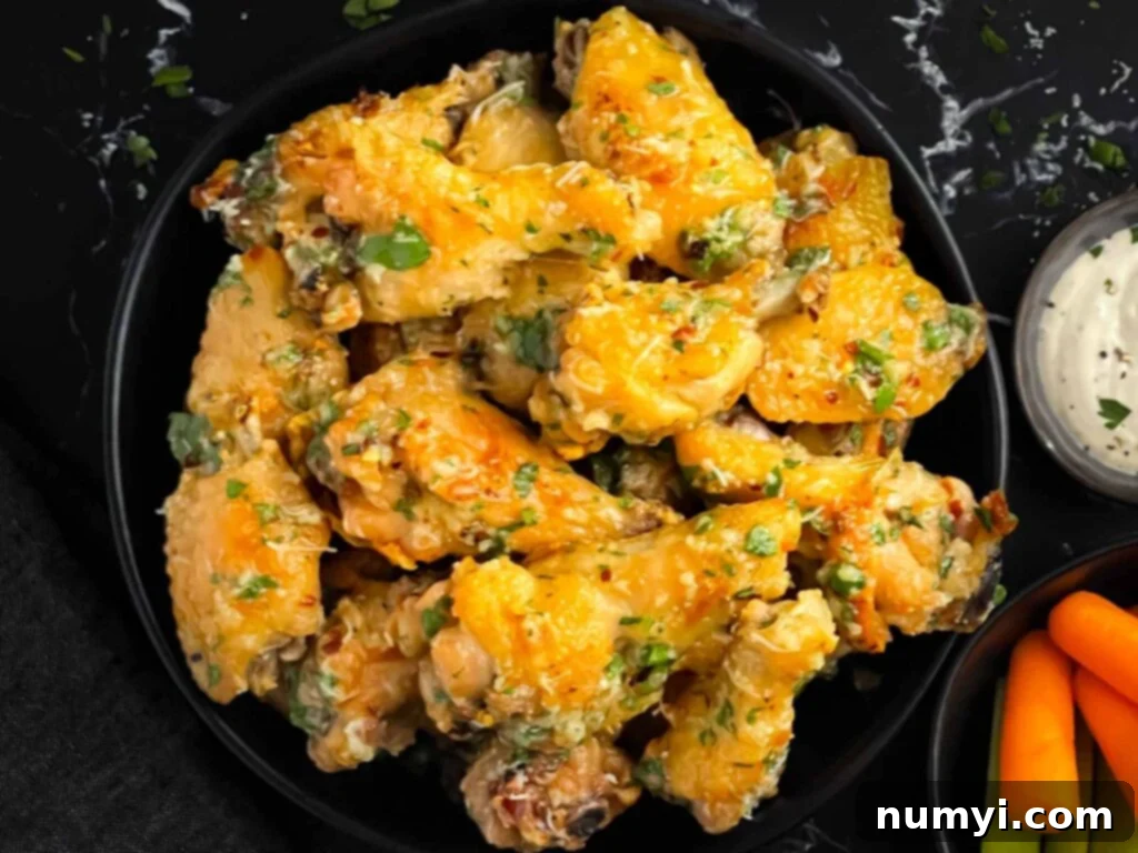 Garlic Parmesan chicken wings on a dark bowl.