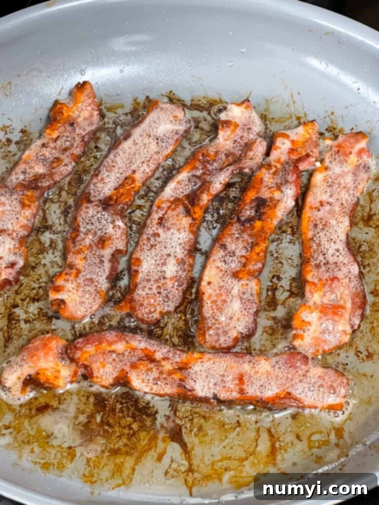 Fried bacon in a skillet.