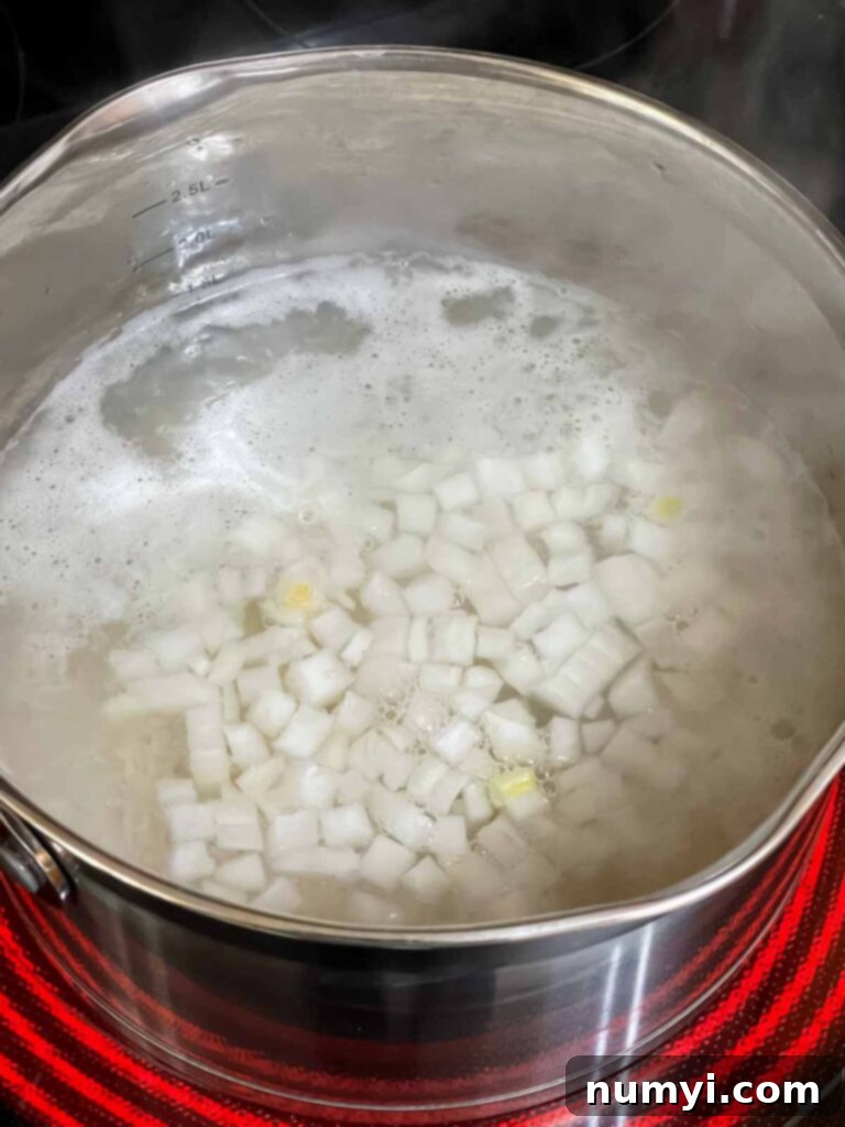 Rice with onions cooking in a saucepan, adding extra flavor.