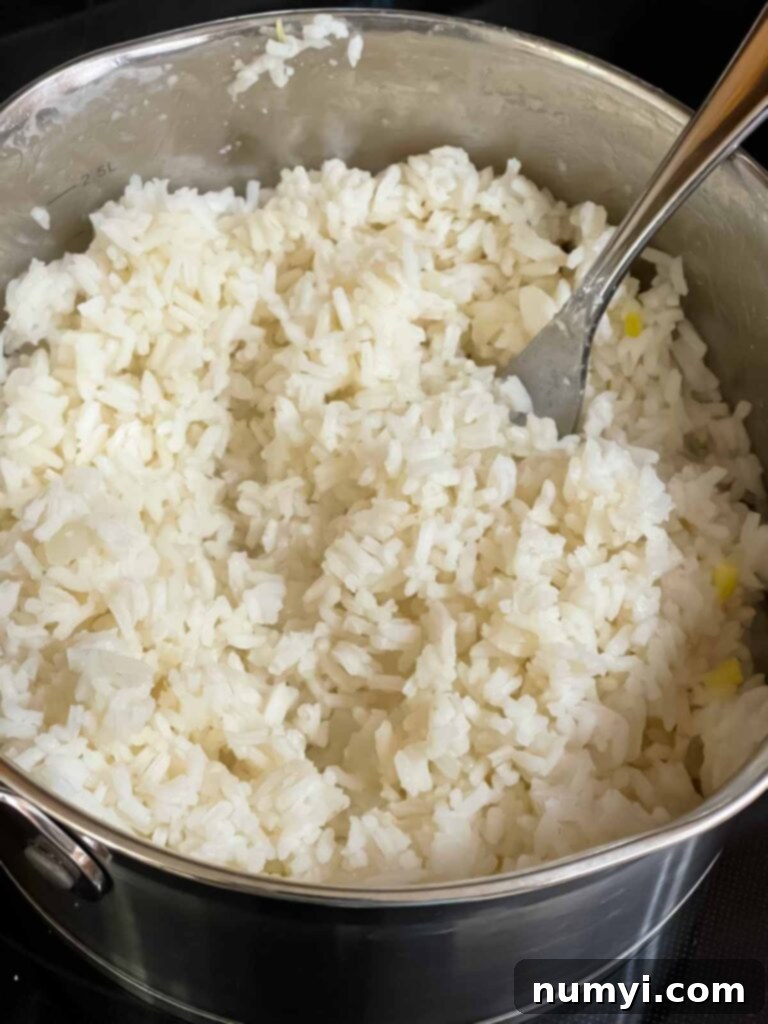 Perfectly cooked white rice in a saucepan, ready for the casserole.