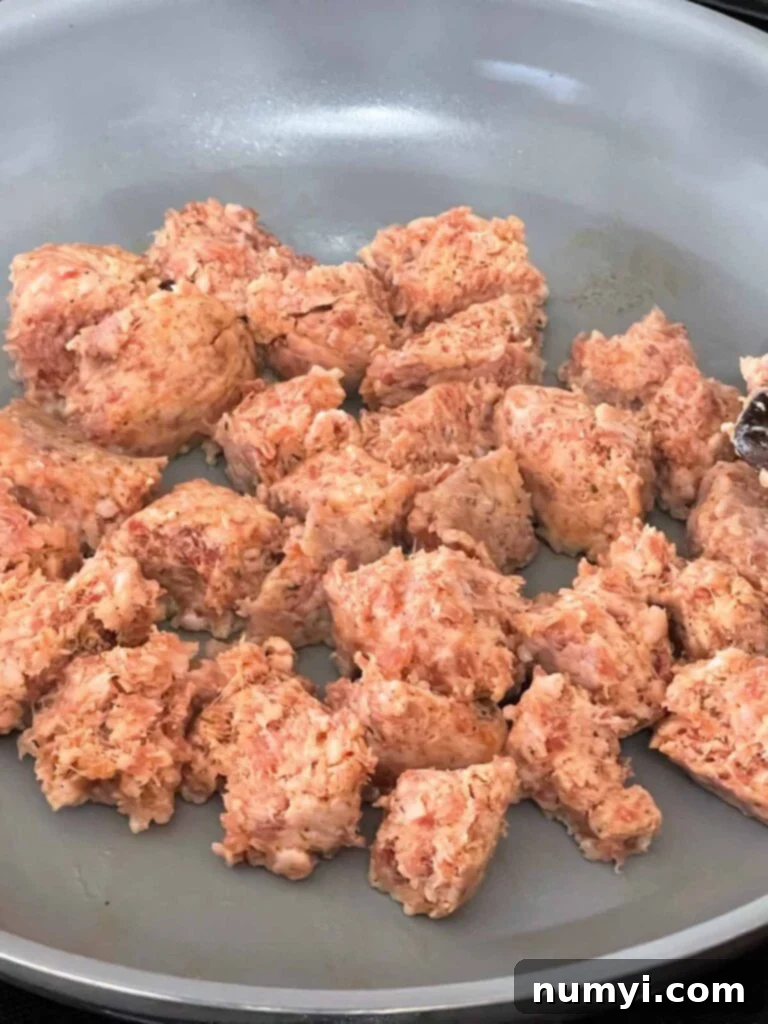 Effortless Country Sausage Gravy 4 Sausage cooking in a skillet.