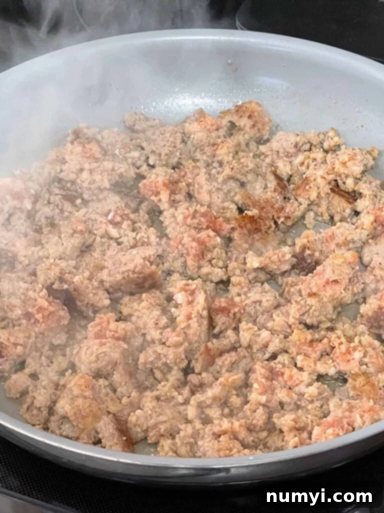 Effortless Country Sausage Gravy 5 Sausage browning in a skillet.