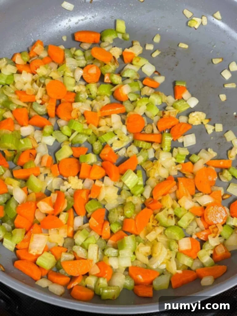 Softened and sautéed mirepoix (onions, celery, carrots) in a skillet after cooking.