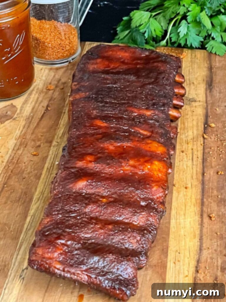 Finished Kansas City style ribs resting on a cutting board after smoking.