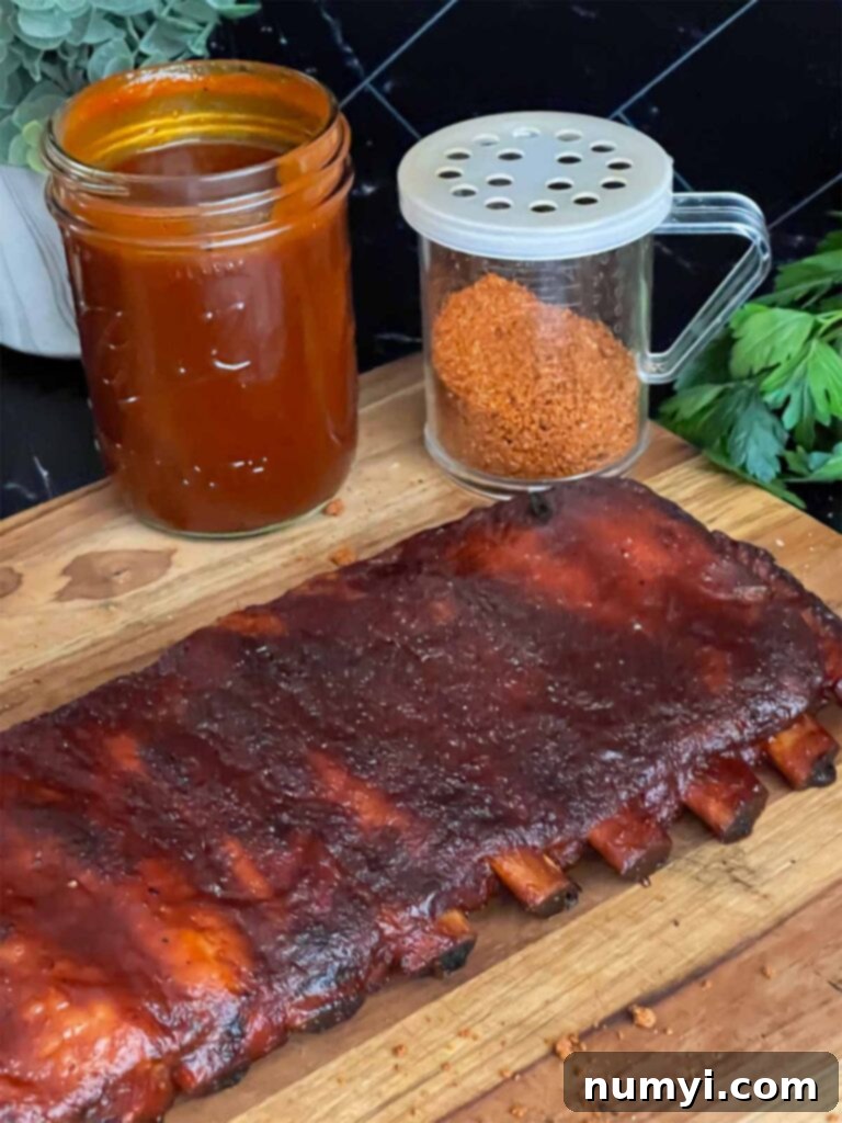 Kansas City style ribs on a cutting board, perfectly sliced and ready to eat.