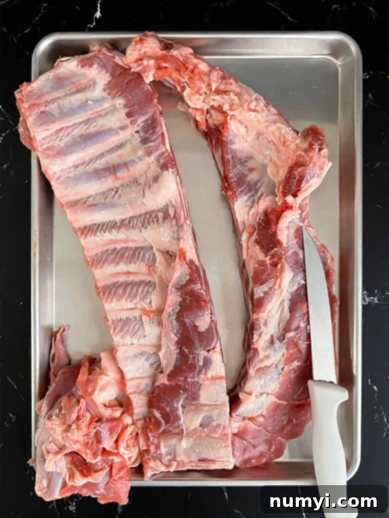 A rack of spareribs expertly trimmed to St. Louis style, ready for seasoning.