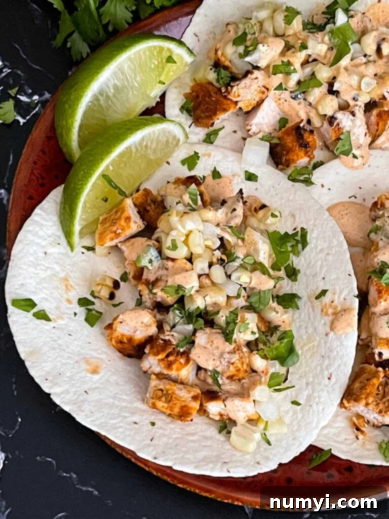 Southwest grilled chicken tacos on a red plate.