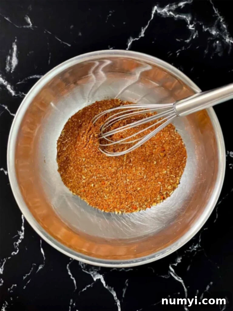 Southwest spices perfectly mixed in a stainless steel bowl, showing an even blend of colors.
