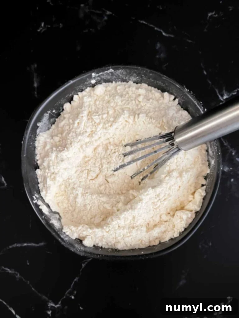 A bowl of flour in a dark bowl.