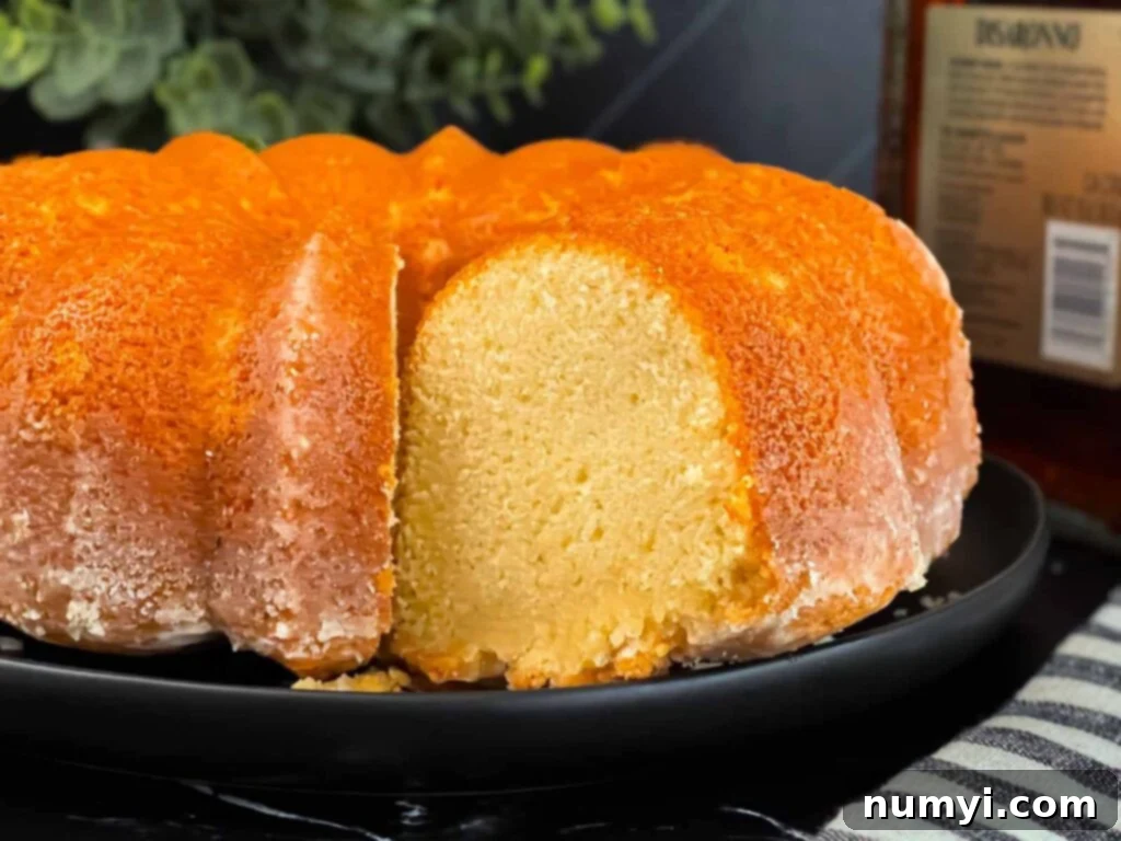 Amaretto pound cake on a black plate, perfectly sliced and ready to serve.
