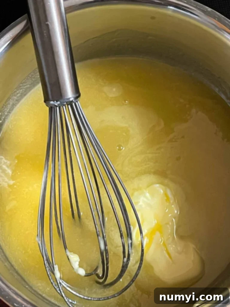Ingredients for the Amaretto glaze being cooked in a small saucepan.