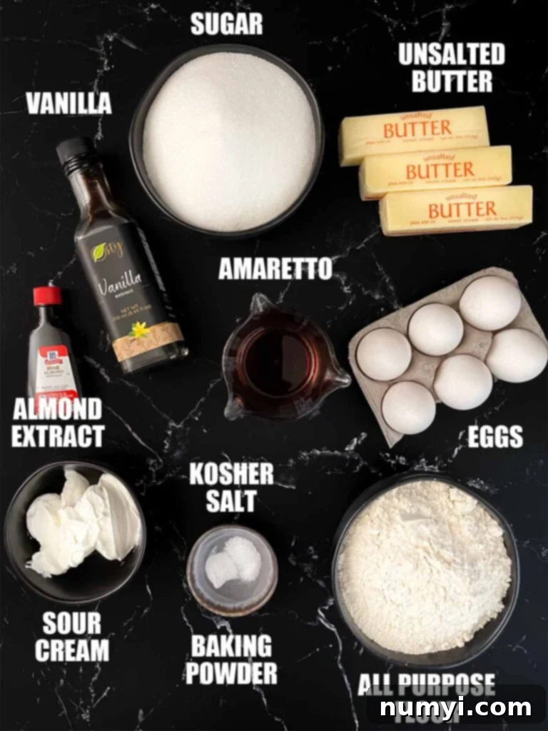 Ingredients needed for an Amaretto pound cake, laid out on a kitchen counter.
