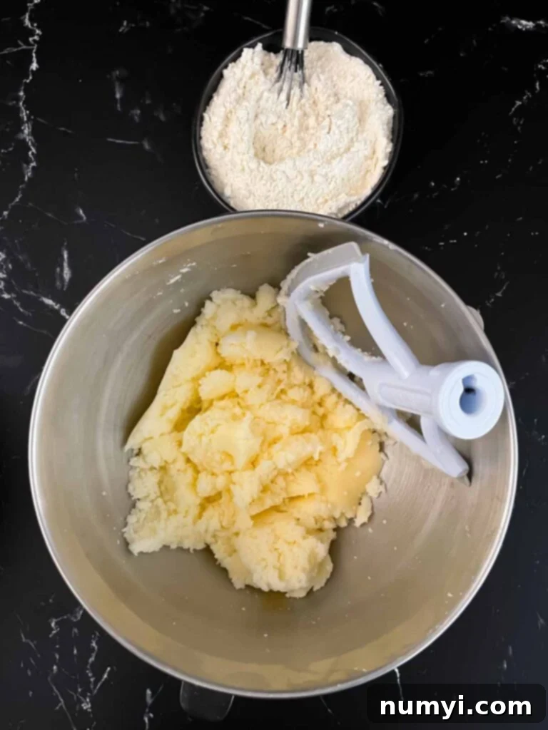 Butter and sugar combined in a mixer, creaming until light and fluffy.