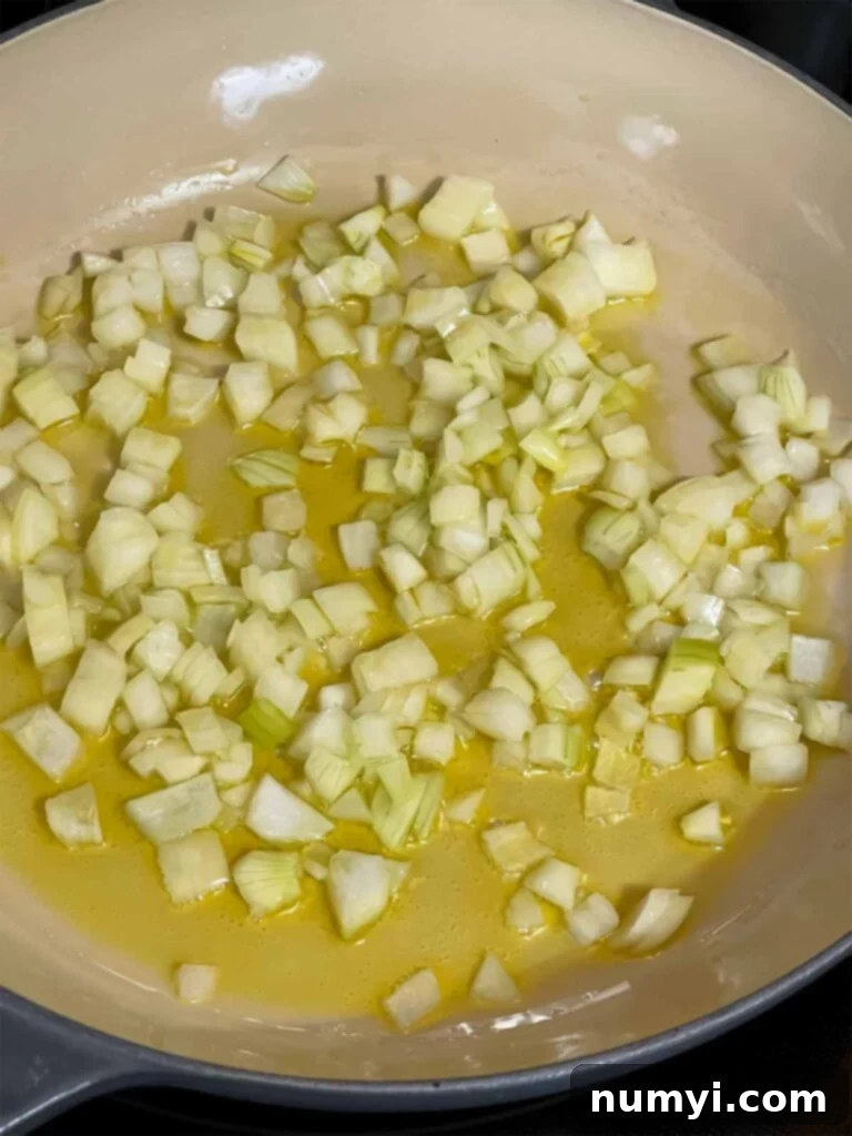 Onions in olive oil cooking.