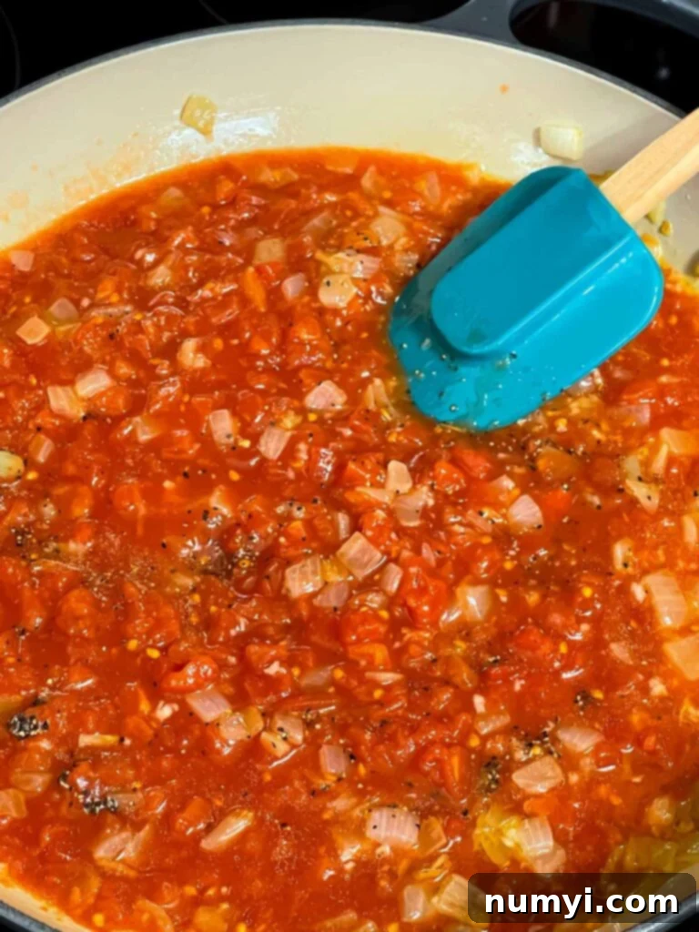 A tomato sauce cooking in a skillet.