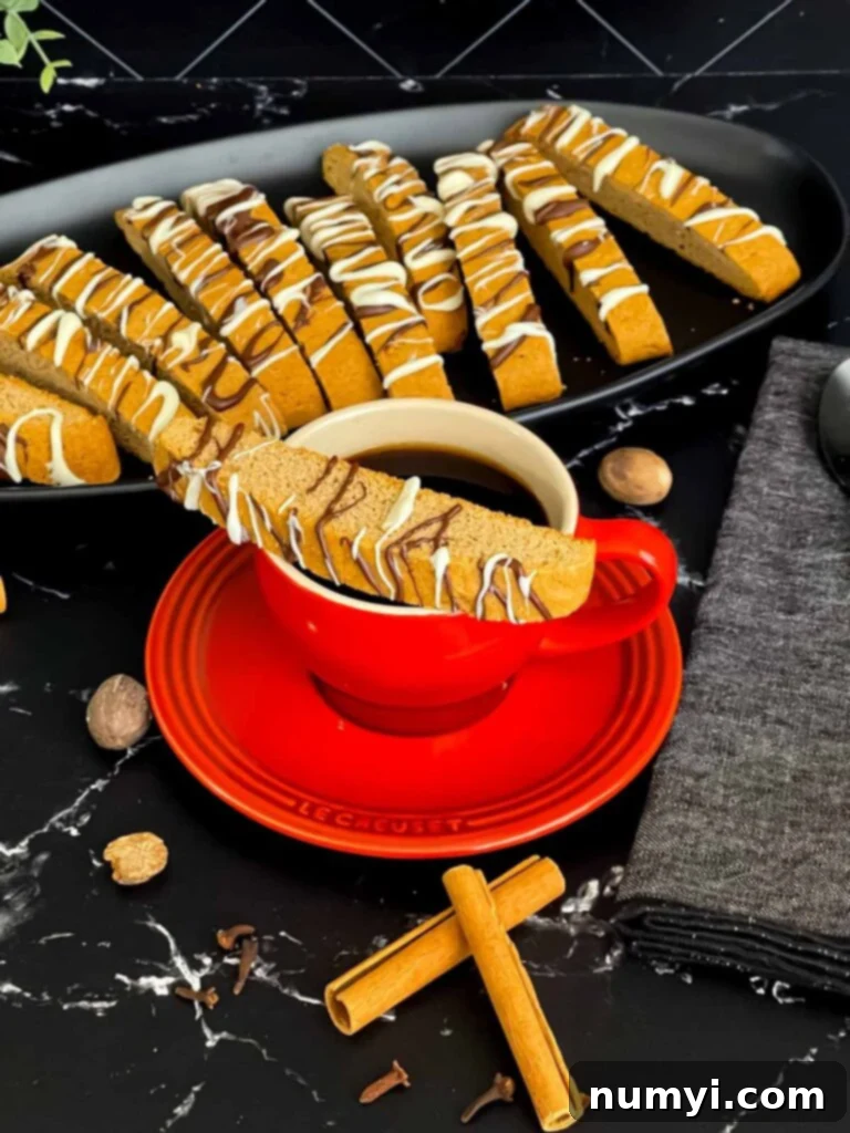 Chai biscotti on a dark plate with coffee.
