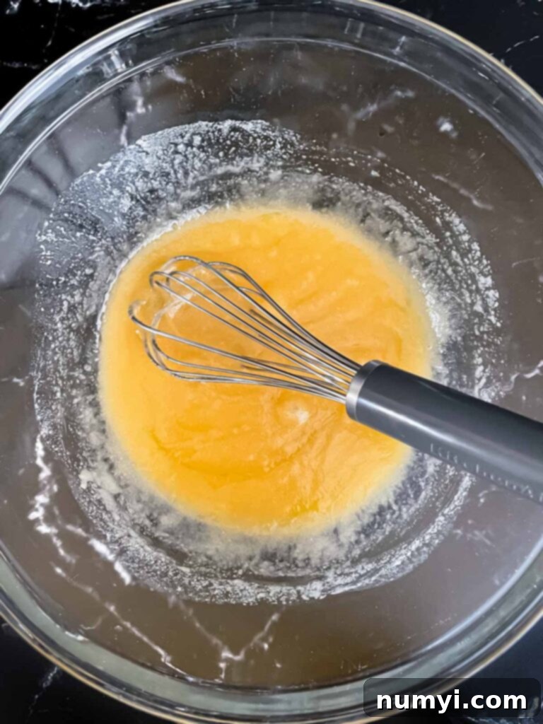 An butter and sugar mixture mixed in a glass bowl.