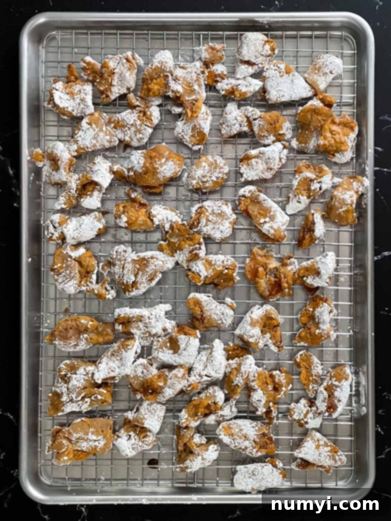 Bite sized chicken thigh pieces covered in cornstarch.