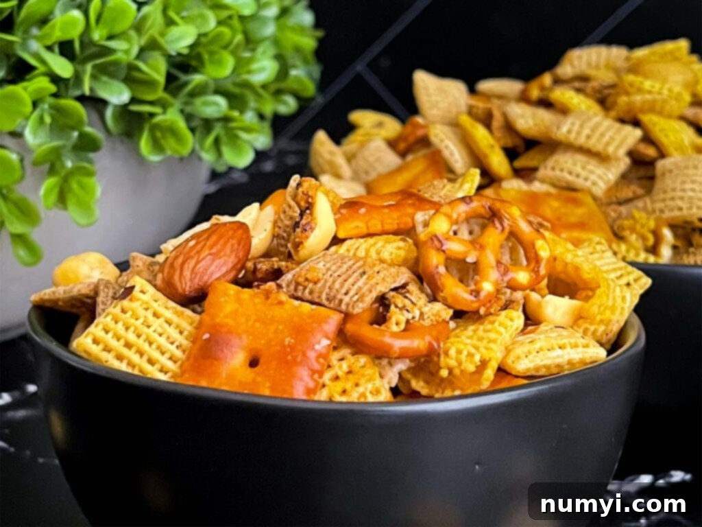 Firecracker Chex Mix in a dark bowl, perfectly seasoned and ready to eat.