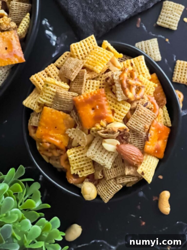 Another view of Firecracker Chex Mix in a dark bowl, ready for serving.