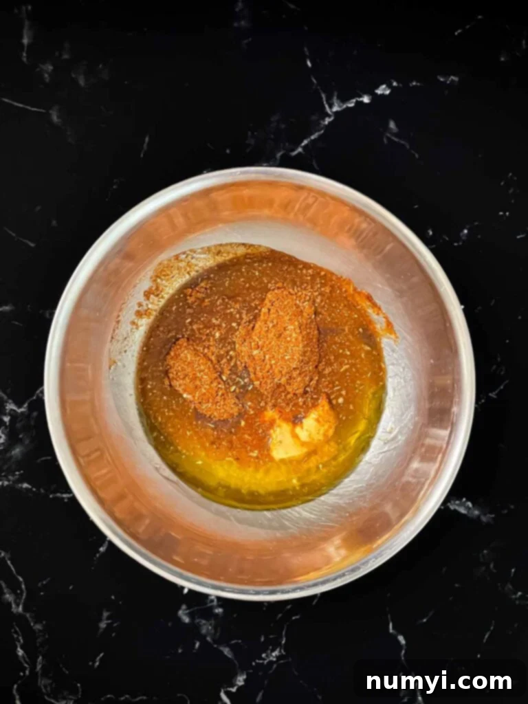 Southwest marinade ingredients combined in a bowl before whisking.