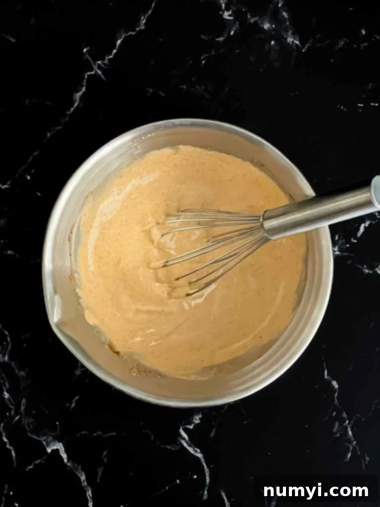 Southwest sauce ingredients whisked together in a bowl.