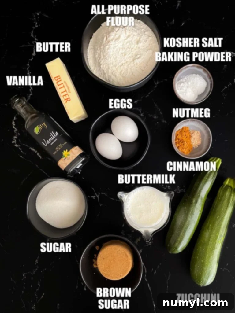 All the essential ingredients for making zucchini muffins laid out on a clean surface, including flour, sugar, eggs, butter, fresh shredded zucchini, and aromatic spices.