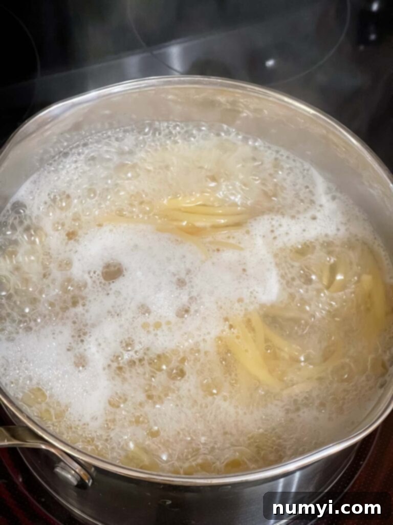 Bucatini boiling in water.